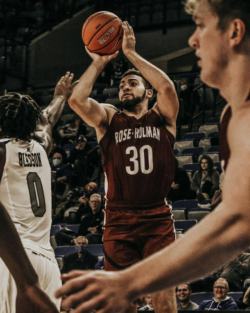 A guard rising for a shot in a packed arena